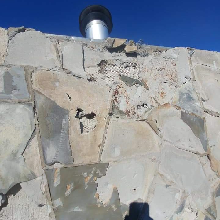 Crumbling mortar and stonework on a chimney.